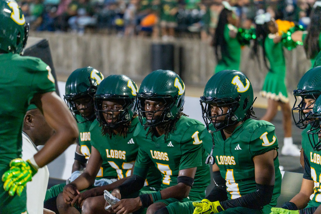 Longview football players listening to the coaches calls.