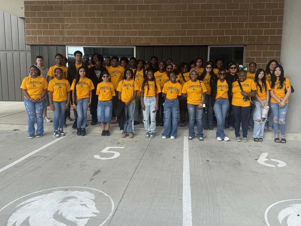 students posing in front of campus