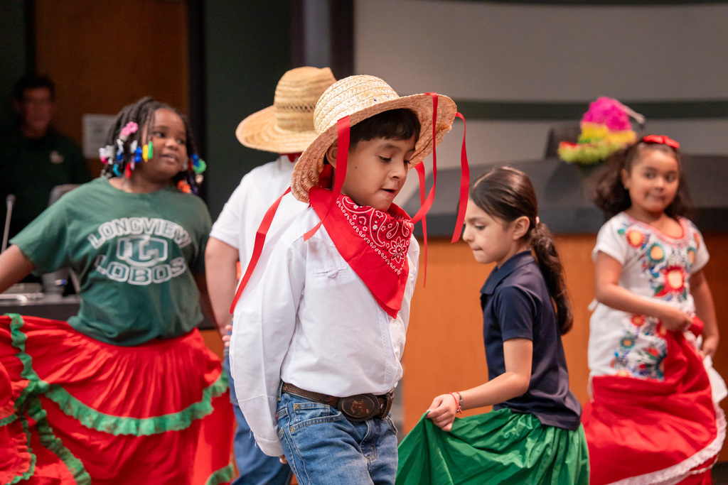 A student dancing in the Hispanic Heritage program at the Education Support Center.