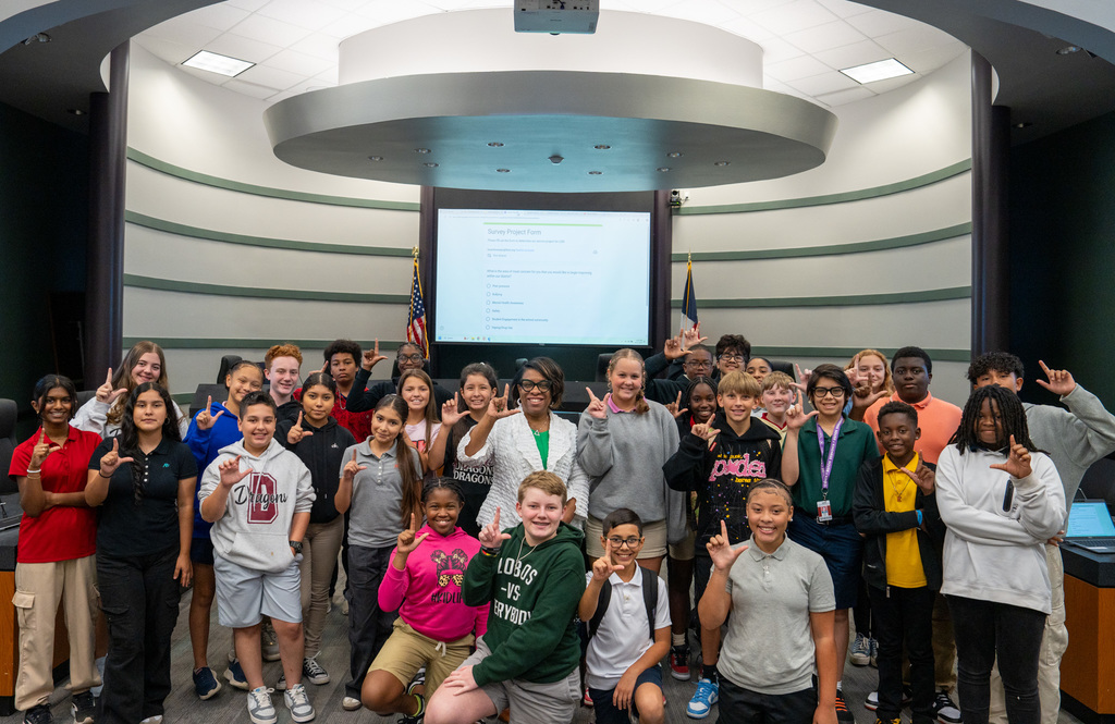 Student advisors holding up the Rocking L.