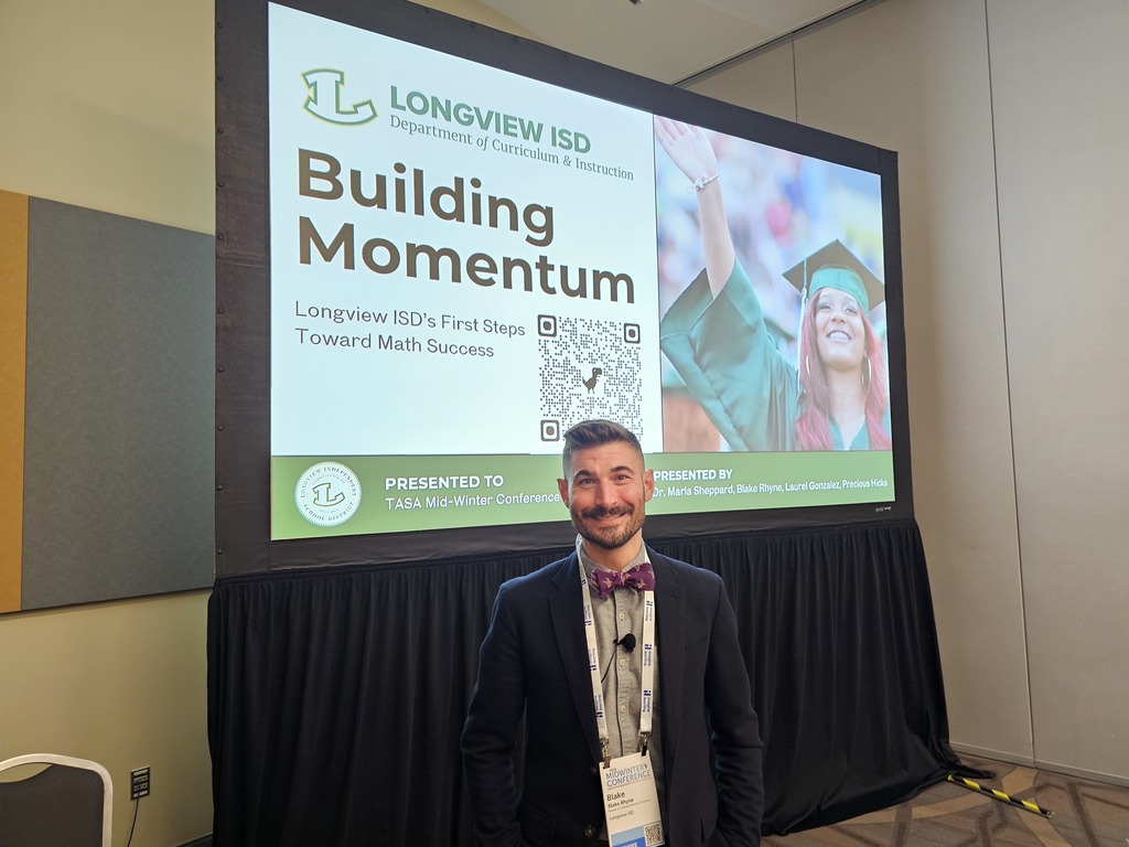 Blake Rhyne standing in front of presentation 