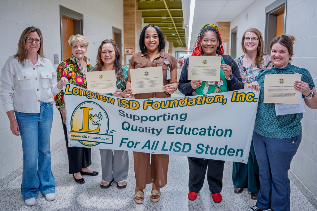 East Texas Montessori Prep Academy teachers with banner.