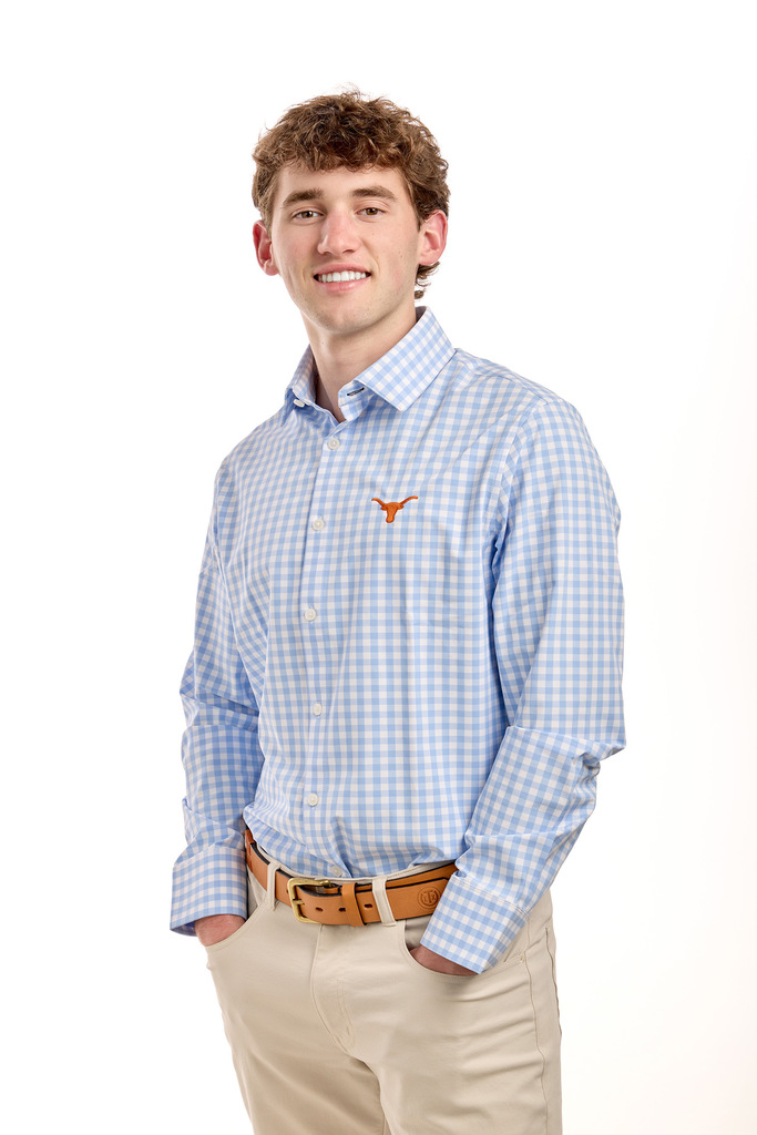 Mason wearing a long sleeved button up shirt with a UT longhorn logo on the chest.