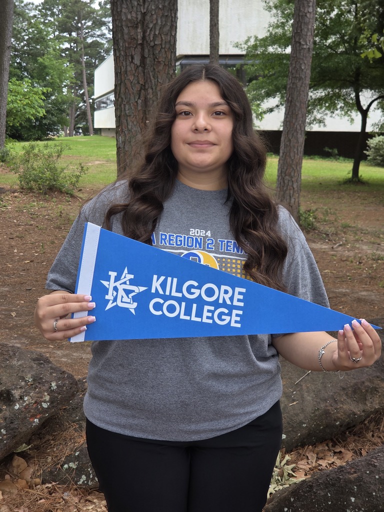 Mayrin outside holding a kilgore college pennant
