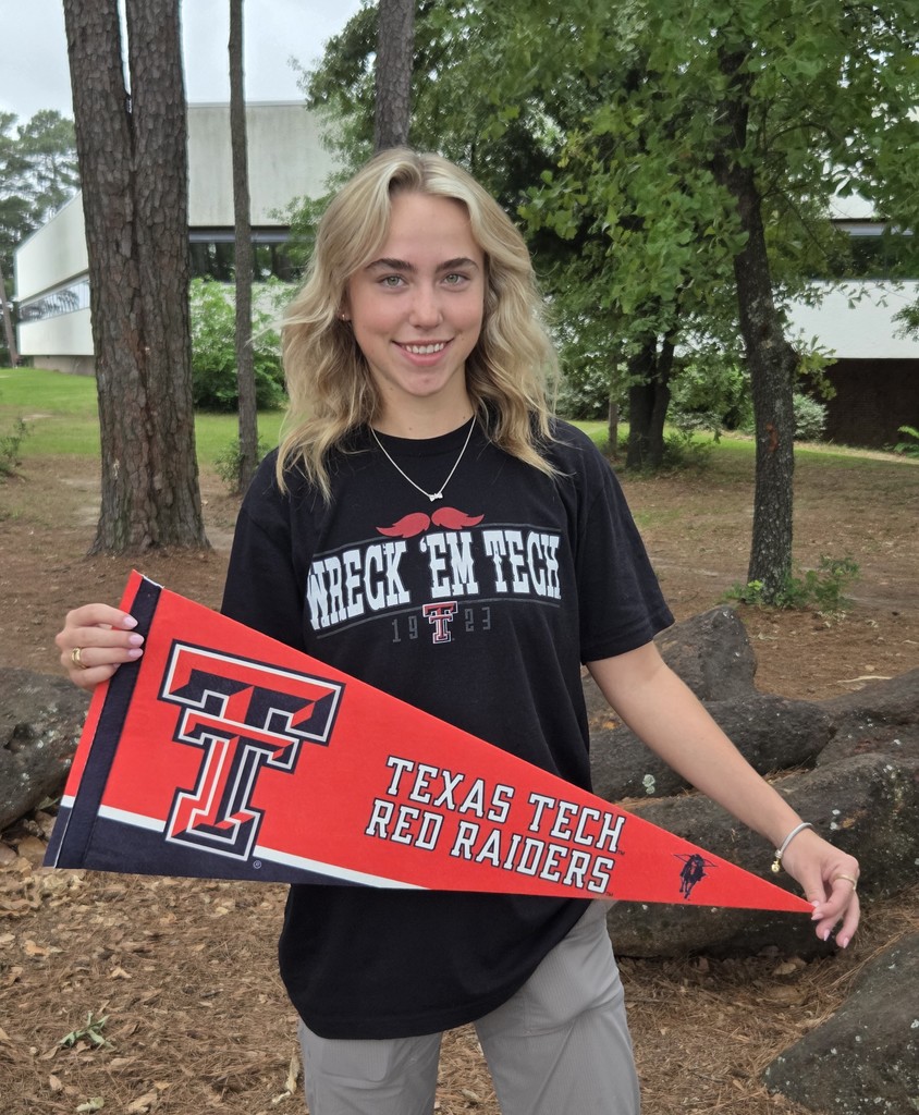 Hannah is wearing a black wreck 'em tech shirt and holding a red Texas Tech Red Raiders pennant