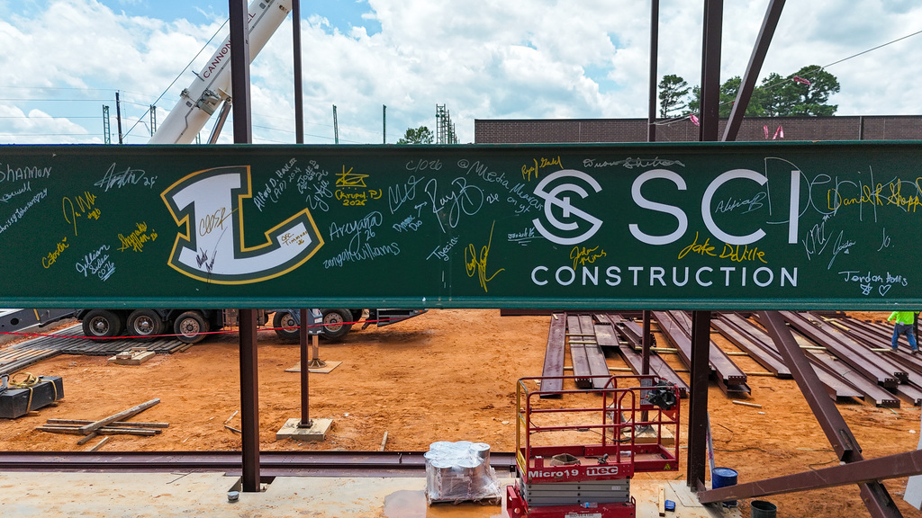 A green steel beam signed by members of Longview High School's 2026 Senior Class installed as part of the new Career and Technical Education Facility