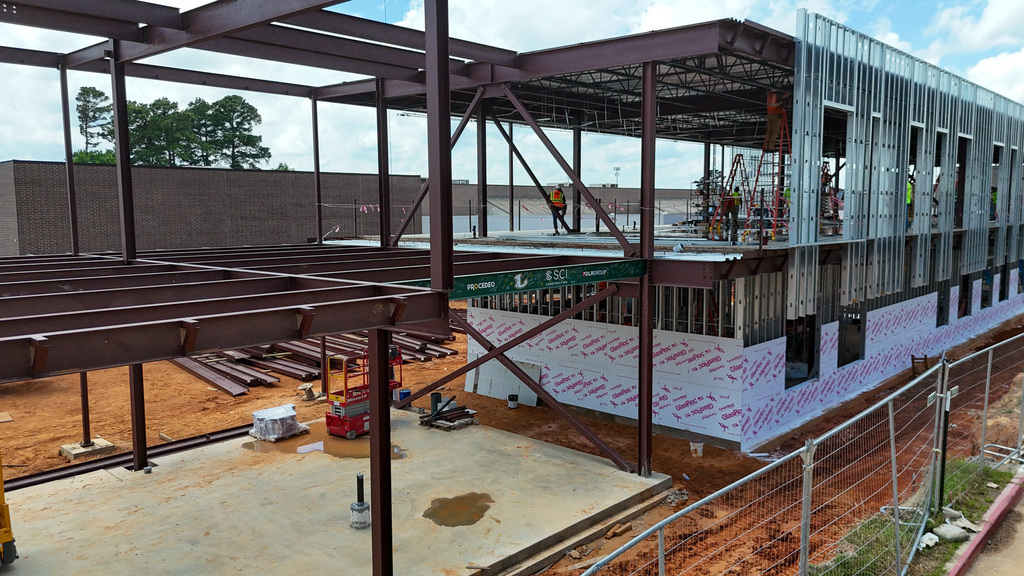 A green steel beam signed by members of Longview High School's 2026 Senior Class installed as part of the new Career and Technical Education Facility