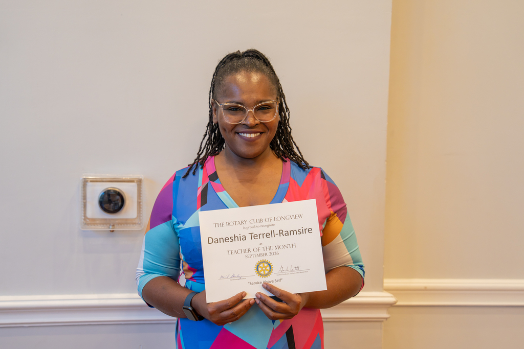 Ms. Ramsire from Forest Park Middle School receiving an award.