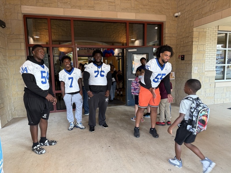 kilgore college players high fiving students