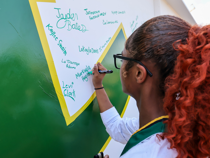 student signing on the rocking L
