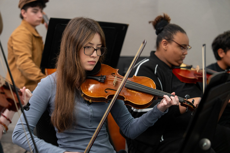 Orchestra students performing at State of the District.