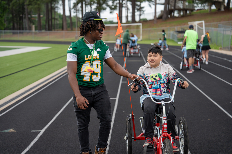student on tricycle.