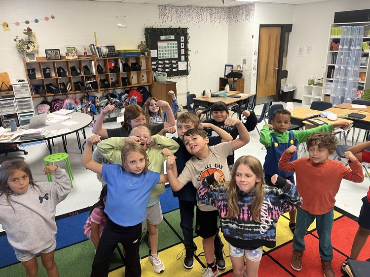students flexing like Hercules