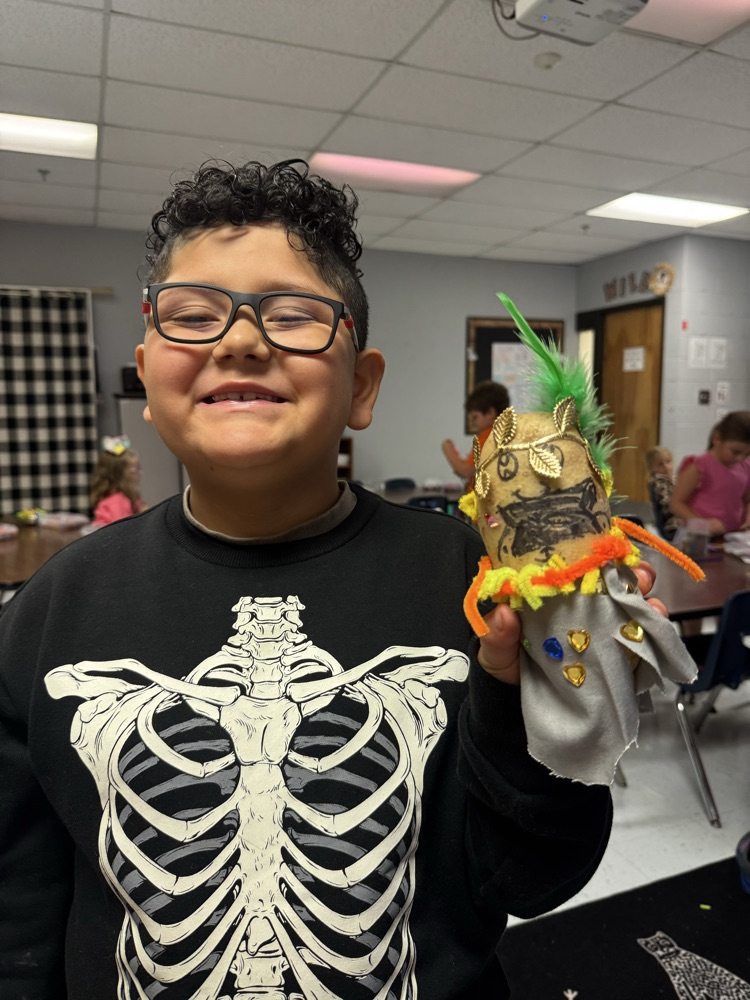 student with Greek god decorated potato
