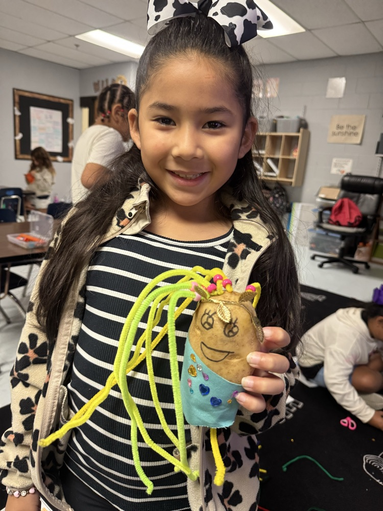 student with Greek god decorated potato