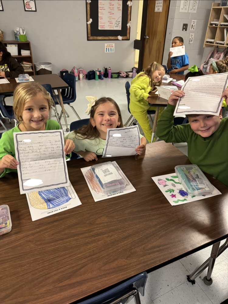 students holding letters
