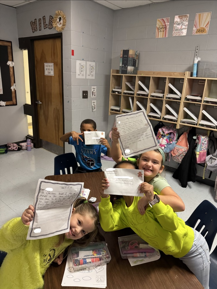 students holding letters