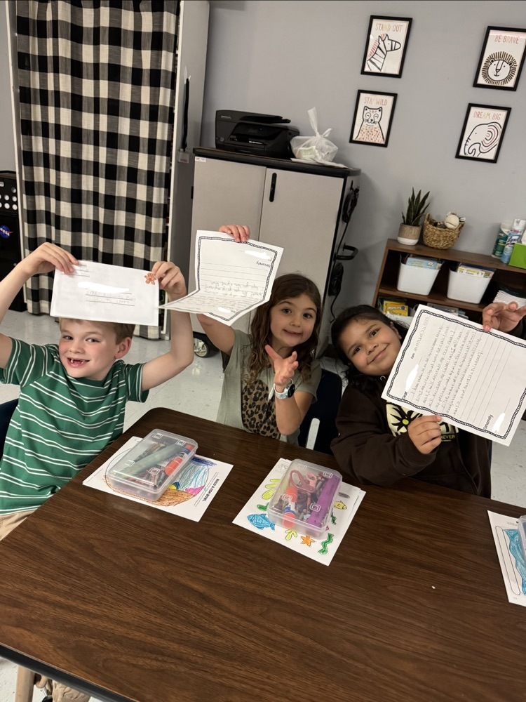 students holding letters