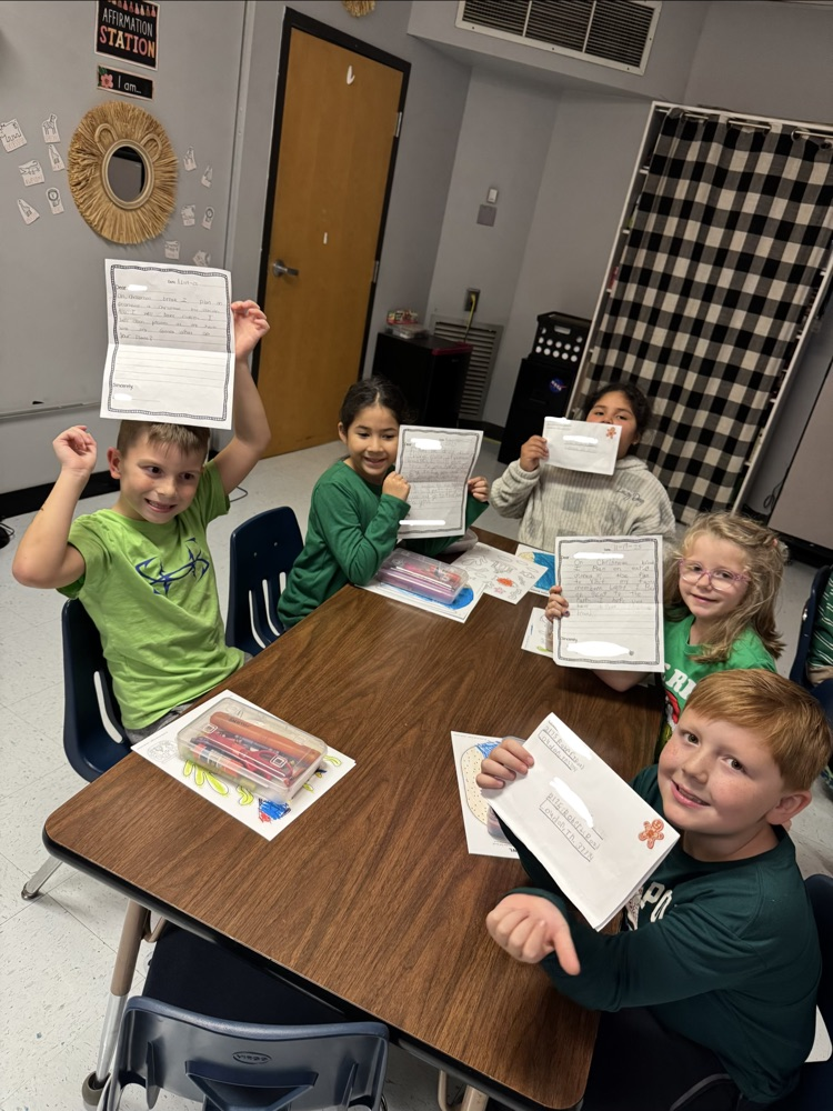 students holding letters