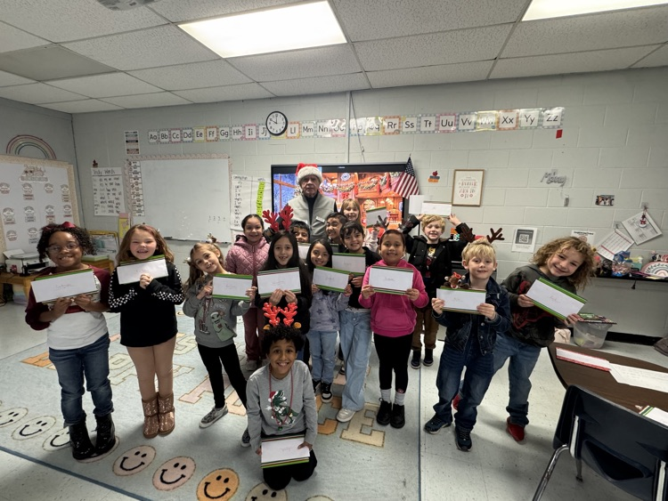 volunteer smiling with students