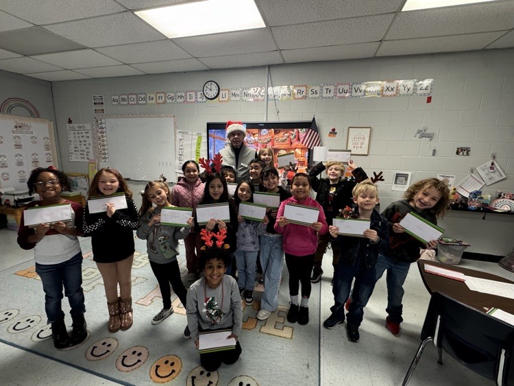 volunteer smiling with students