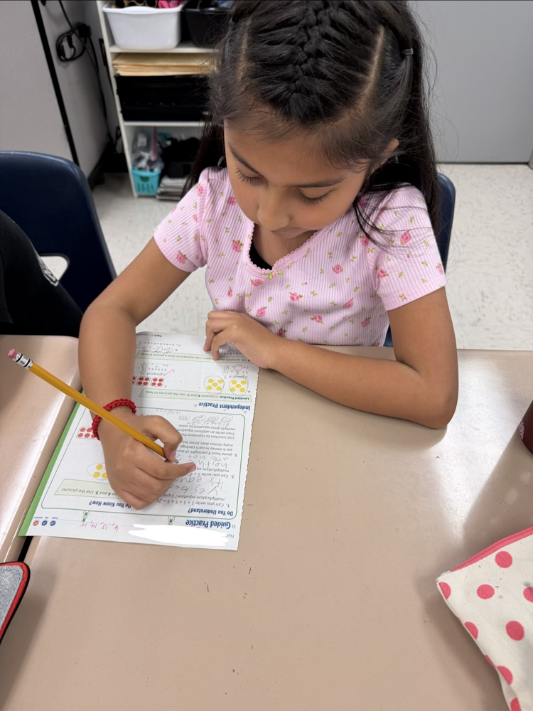 student working on a math paper
