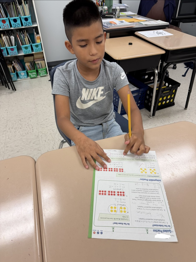 student working on a math paper