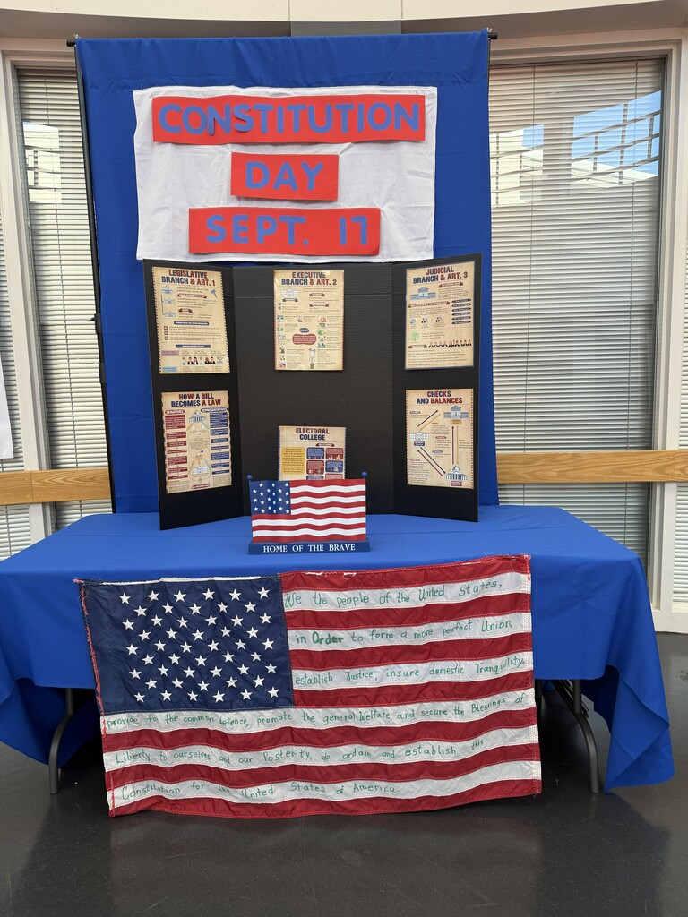 Display on a table with an American flag. Information about Constitution Day on Sept. 17 on a banner.