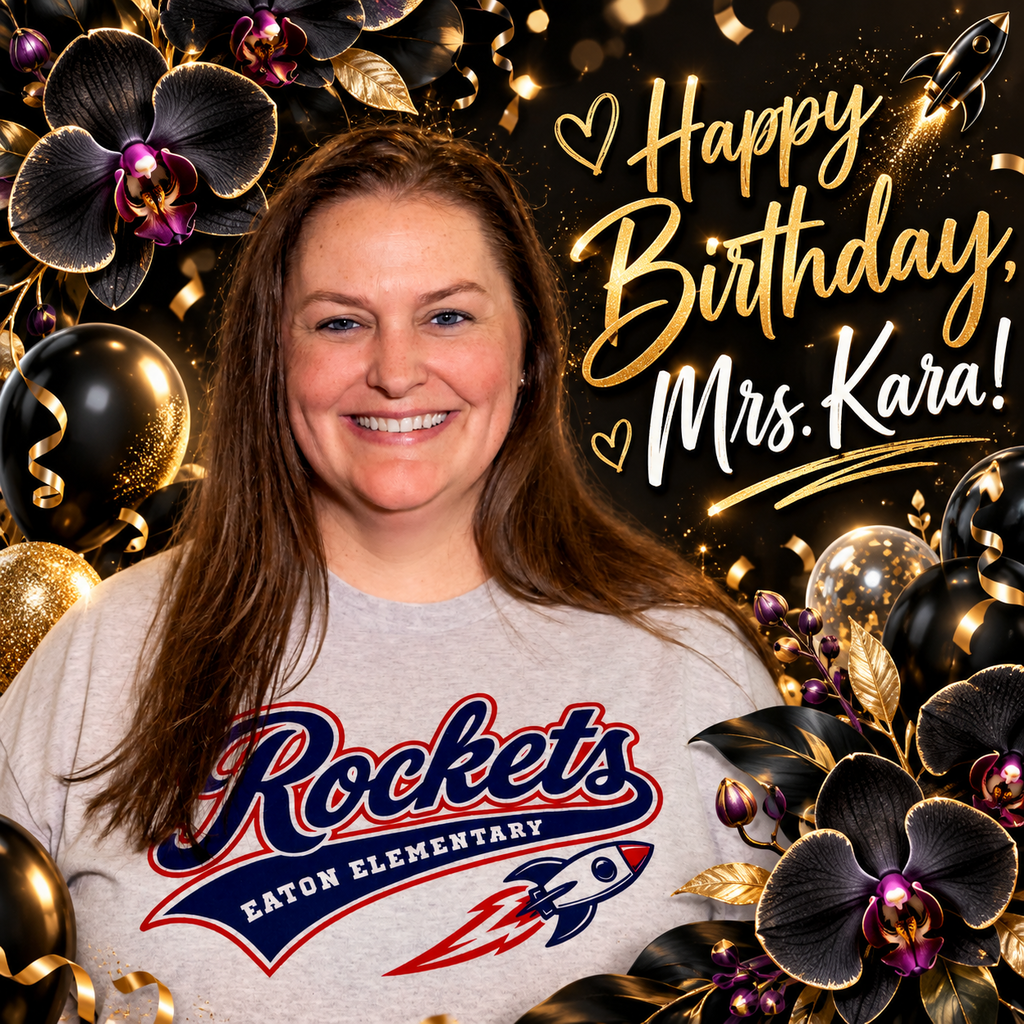 A woman with a smile stands before a colorful backdrop with balloons and flowers. She wears a Rockets Elementary t-shirt.