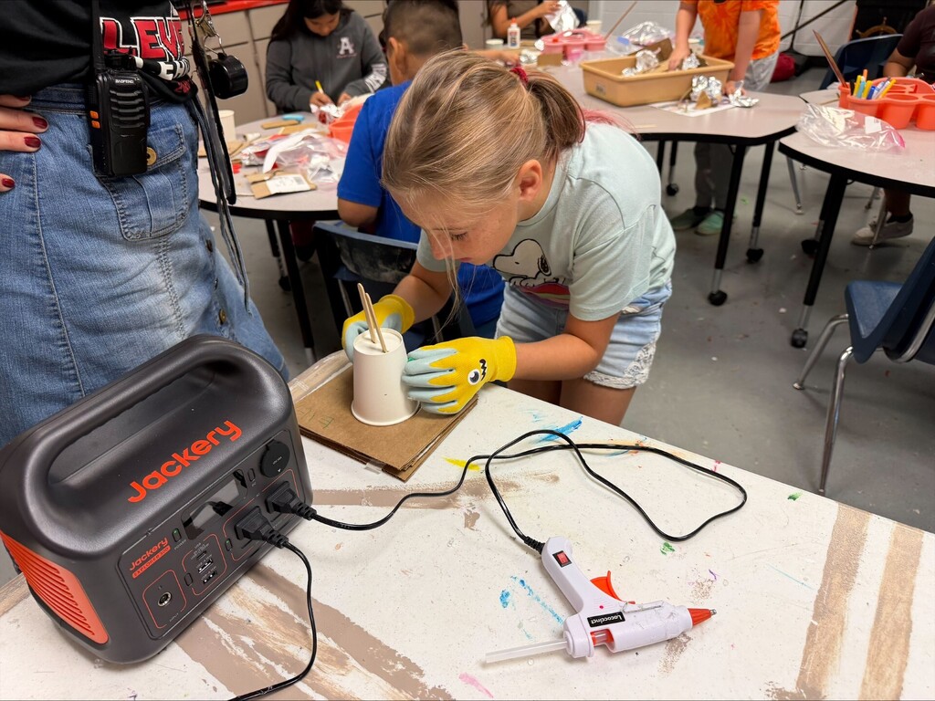using hot glue to create her robot