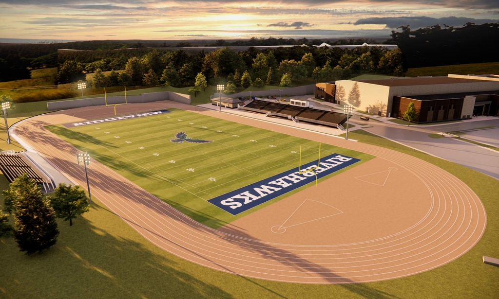 Aerial view of a sports field with a grass pitch and a running track around it.
