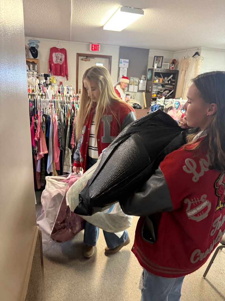 Students assisting with bags