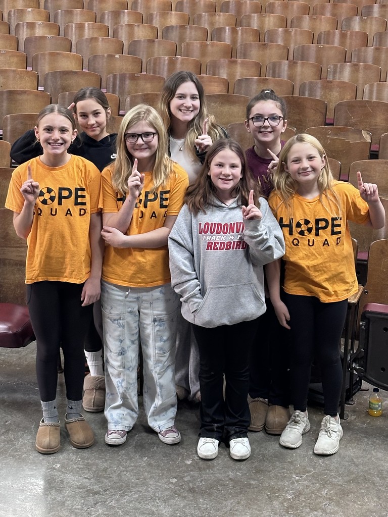 Hope Squad students grouped in front of auditorium seating for a photo.