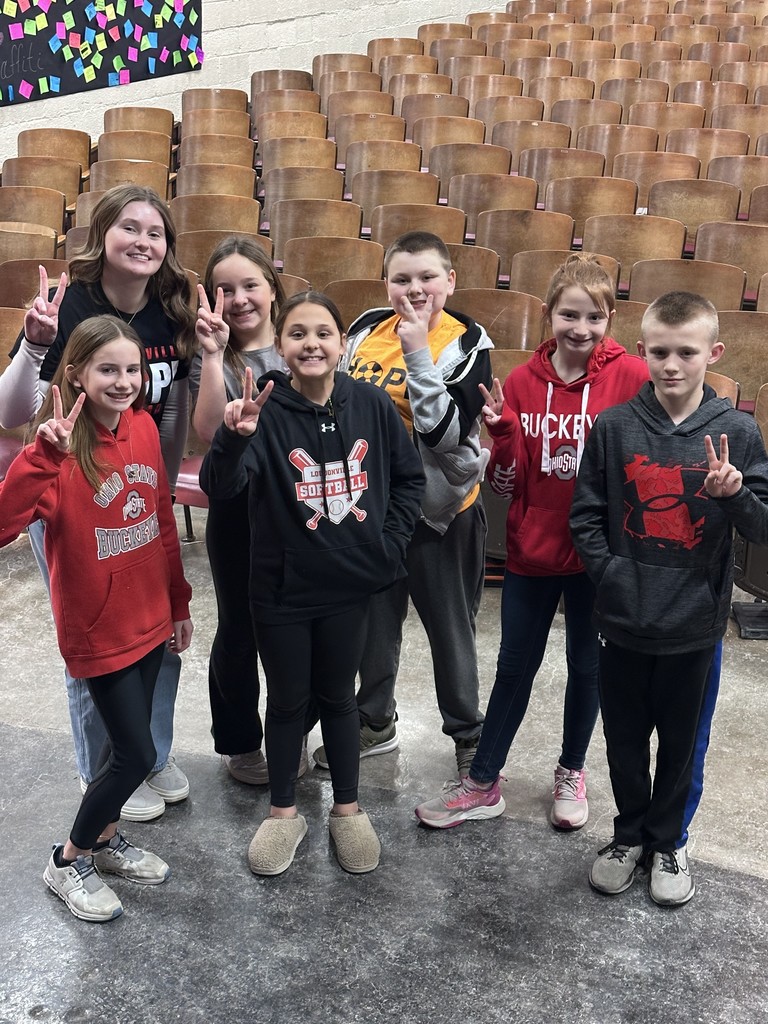 Hope Squad students grouped in front of auditorium seating for a photo.