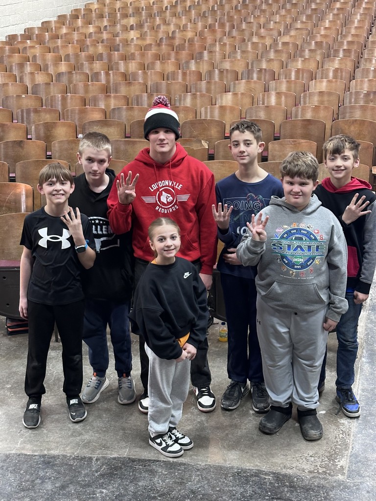 Hope Squad students grouped in front of auditorium seating for a photo.