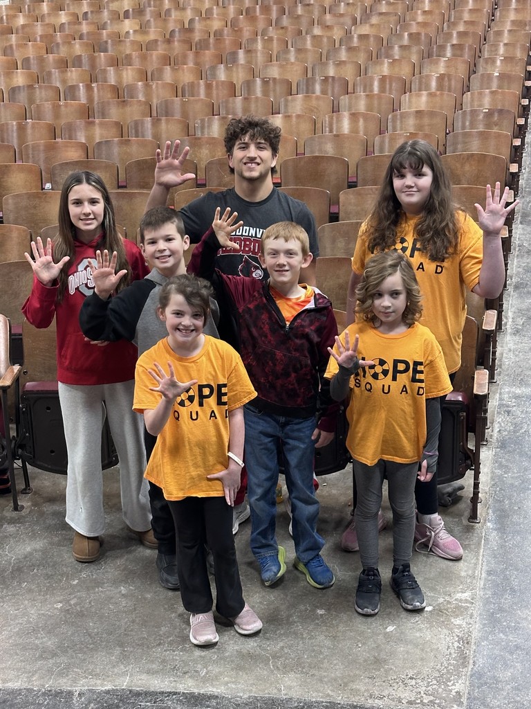 Hope Squad students grouped in front of auditorium seating for a photo.