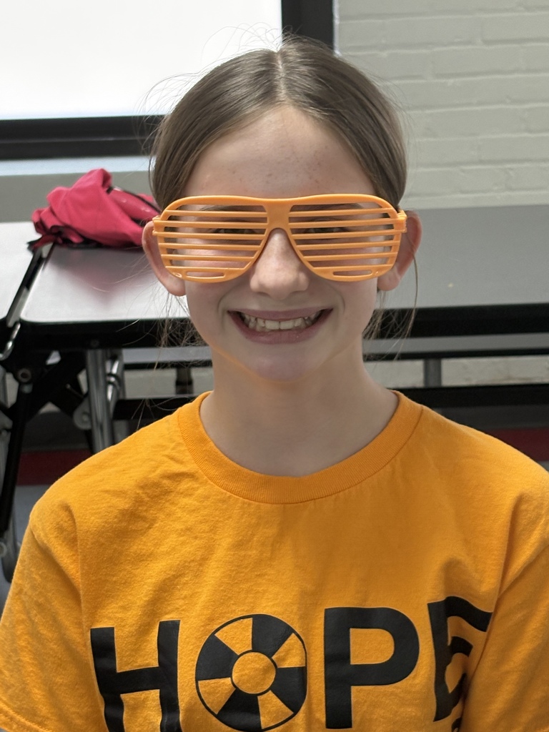 Student wearing neon orange glasses