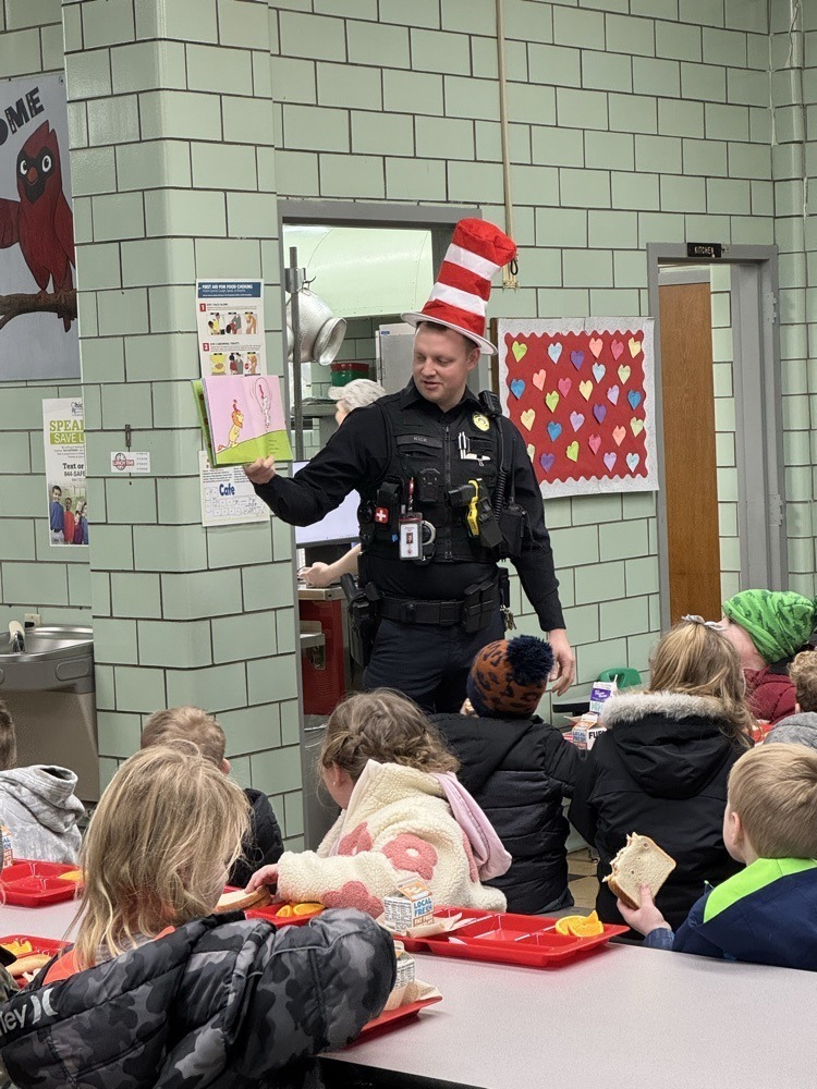 Sergeant Kick reading to students in the cafeteria