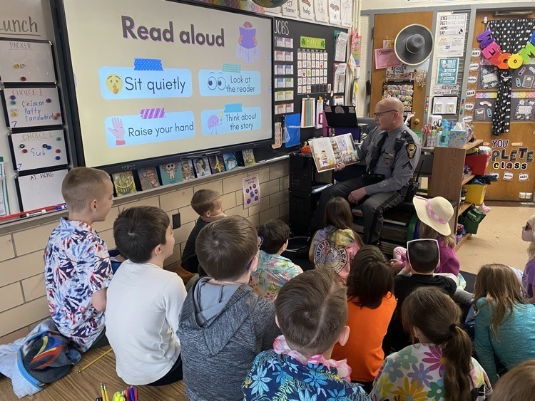 Sherriff reading to classroom of students