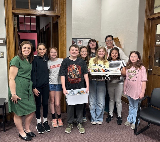 Members of the Hope Squad posed with District Staff with snack baskets that were dropped off. 