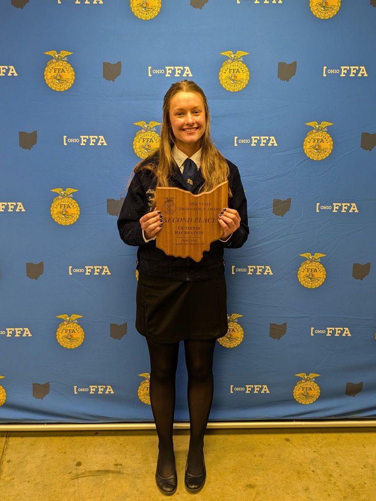 Photo of Abby holding her award. 