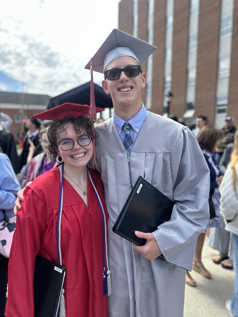 Photo of one female and one male graduate