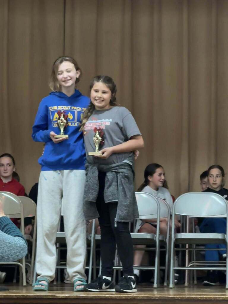 This year's spelling bee winners with trophies. 