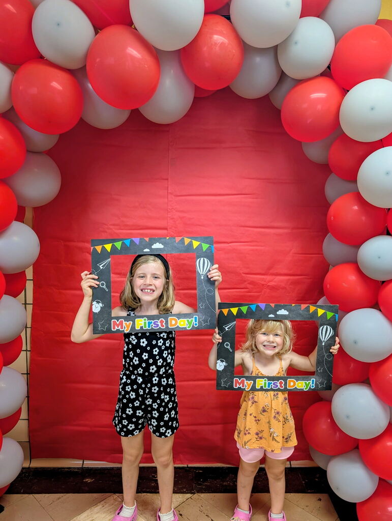 Students with photo frames for the first day.