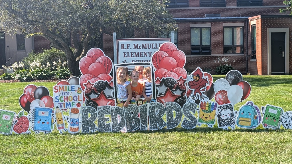 Students posed behind Redbirds sign and balloons.