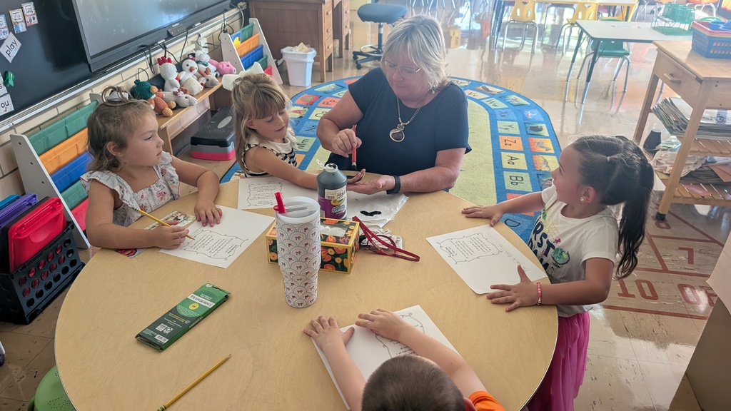 Students working on art project with a teacher.