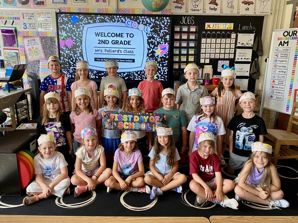 Students in second grade classroom with first day of school hats.