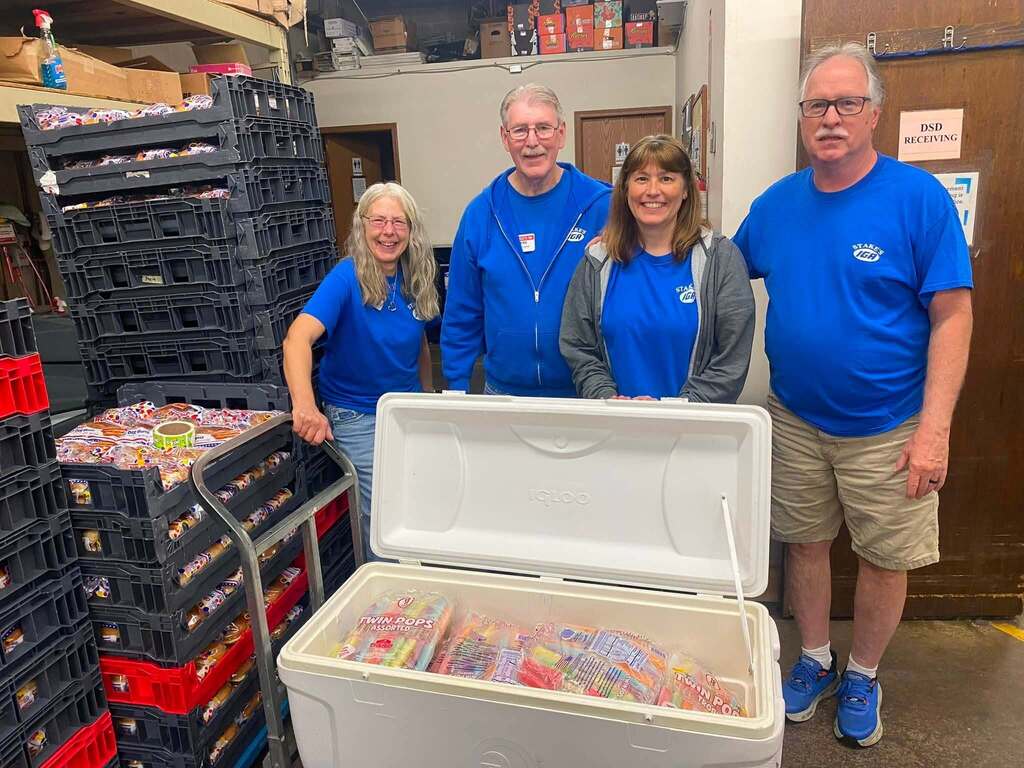 IGA Staff with cooler of popsicles. 
