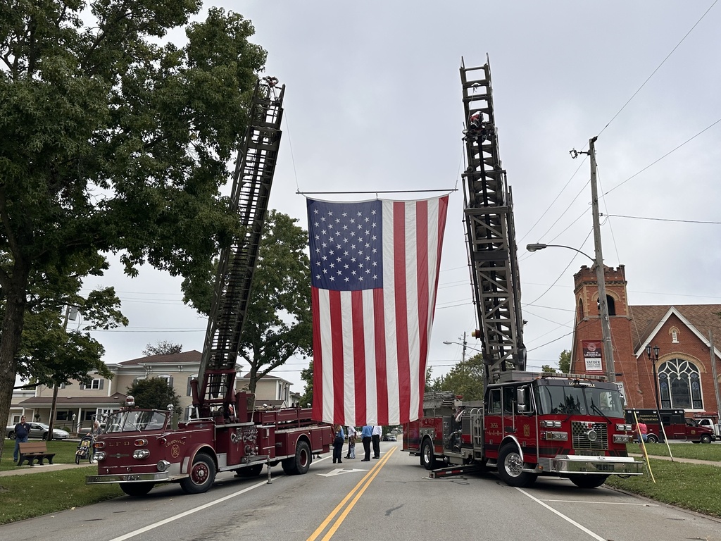 Fire trucks flying the American flag. 