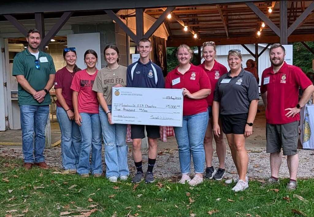 FFA student and alumni and supporters posed for photo with donation check.